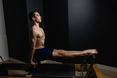 Side view of man exercising in gym