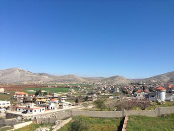 Townscape against clear blue sky