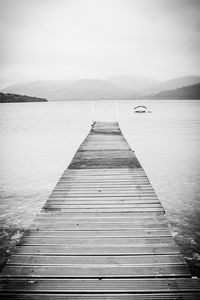 Pier over lake against sky