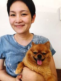 Portrait of smiling woman with dog