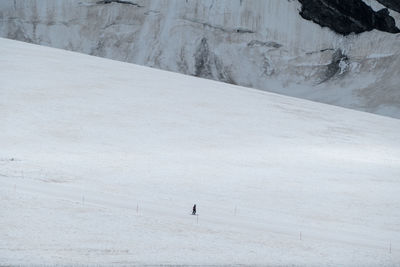 High angle view of person walking on snow covered land