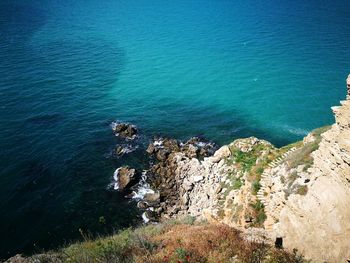 High angle view of sea by cliff