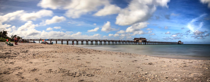 Panoramic view of beach against cloudy sky