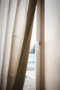 Close-up of curtain against window at home