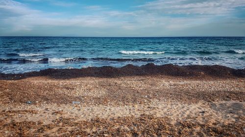 Scenic view of sea against cloudy sky