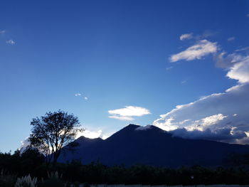 Scenic view of mountains against blue sky