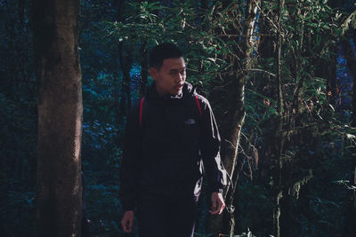 Full length of young man looking at forest