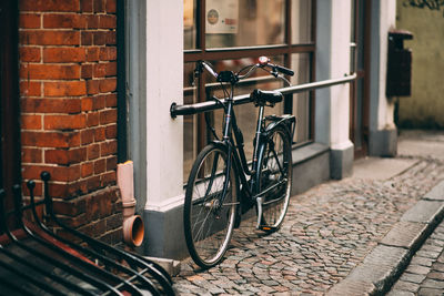 Bicycle on street against building