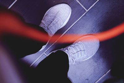 Low section of man standing on hardwood floor