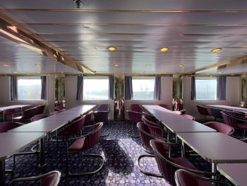 Empty chairs and tables in restaurant ship