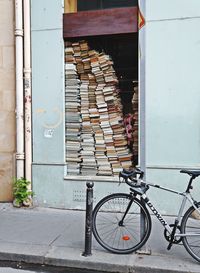 Bicycle leaning against wall of building