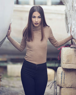 Young woman wearing hat standing outdoors