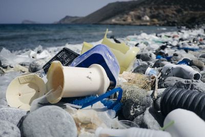 Plastic waste on stones at beach