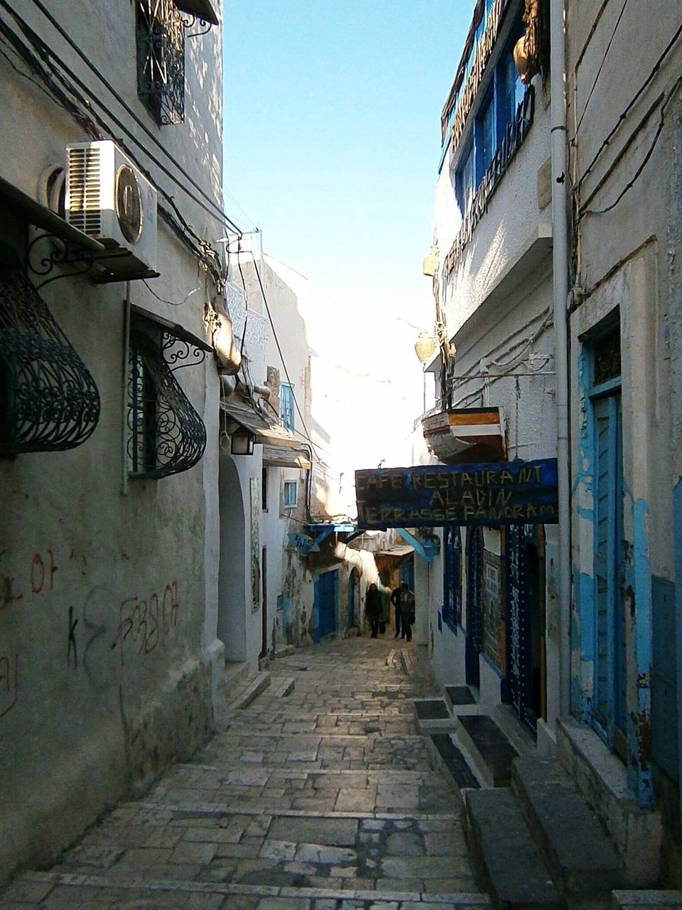 COBBLESTONE STREET AMIDST BUILDINGS IN CITY