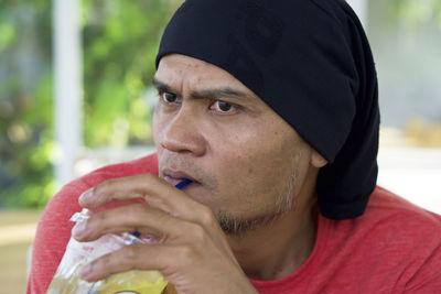 Close-up portrait of young man looking away