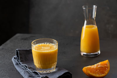 Glass of juice and drink on table