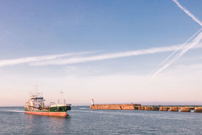 The small jetty and the green lighthouse in les sables d'olonne
