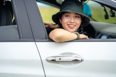 Portrait of smiling woman in car