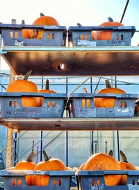 Boats moored at harbor against sky