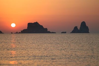 Scenic view of sea against orange sky