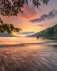 Scenic view of beach against sky during sunset