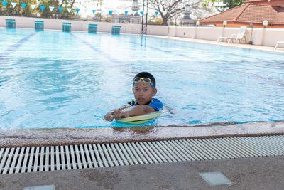 Portrait of boy swimming in pool