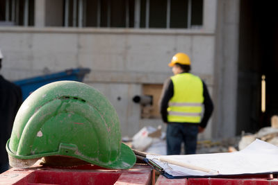 Close-up of green hardhat on table at construction site