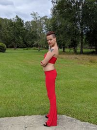 Full length portrait of young woman standing on land 