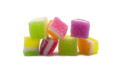 Close-up of multi colored candies against white background