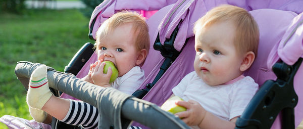 Portrait of cute baby girl sitting in park