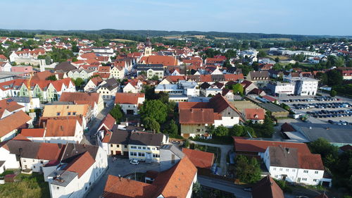 High angle view of houses in town against sky