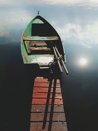 Ship moored in lake against sky
