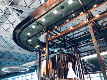 Low angle view of illuminated pendant lights hanging from ceiling