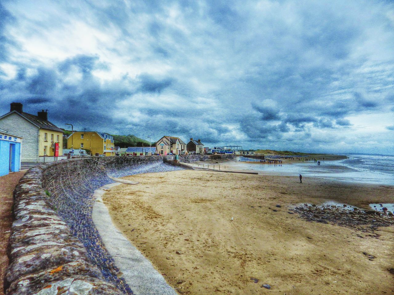 VIEW OF BEACH AGAINST CLOUDY SKY