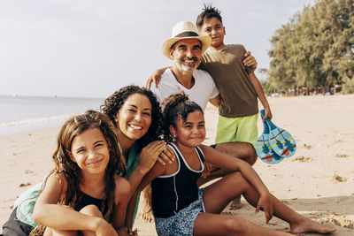Portrait of happy family posing at beach on vacation