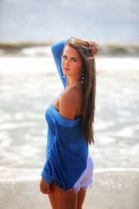 Beautiful woman standing at beach