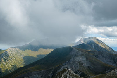 Scenic view of mountains against sky in montemonaco, marche italy