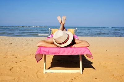 Woman sunbathing on the deck chair 