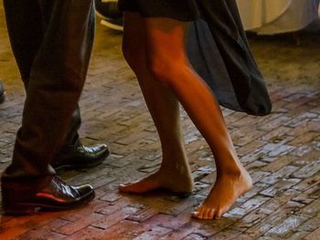 Low section of people on tiled floor