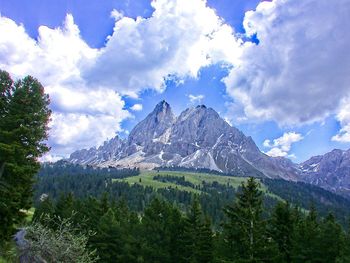 Scenic view of mountains against cloudy sky