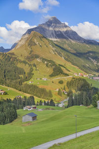 Scenic view of field and mountains against sky