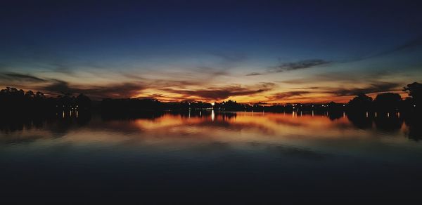 Scenic view of lake against sky during sunset