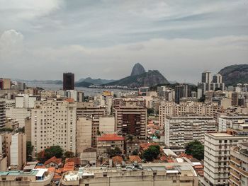 Cityscape against cloudy sky