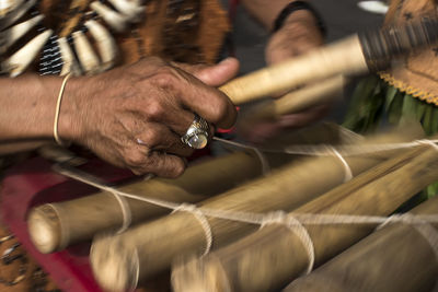 Midsection of person holding wood