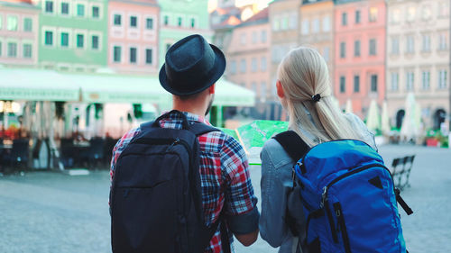 Rear view of people walking on street