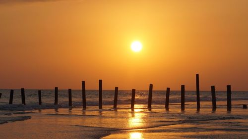 Scenic view of sea against orange sky