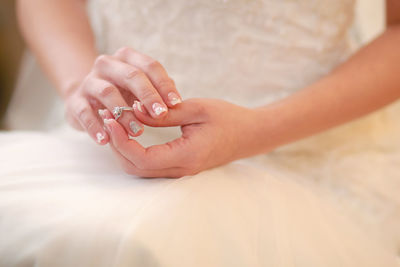 Midsection of bride wearing ring during wedding ceremony