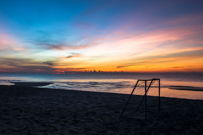 Scenic view of beach against sky during sunset