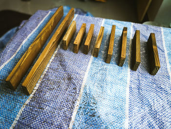 Woodworking, wood planks arranged on blue canvas in a workshop