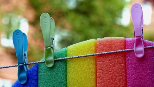 Close-up of clothespins hanging on rope